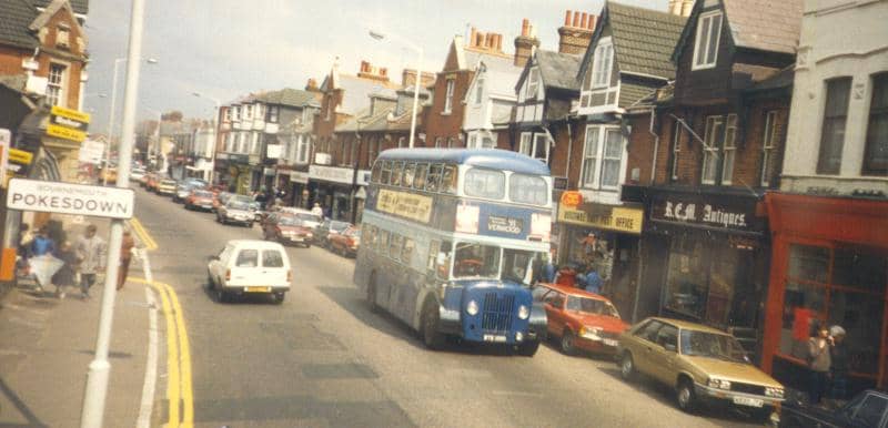 colour photo of a blue bus driving along Christchurch Road, Pokesdown, late 1980s